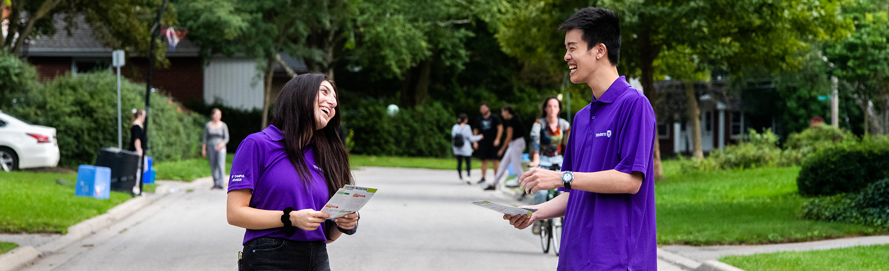 Two Off-Campus Advisors talking on a public street